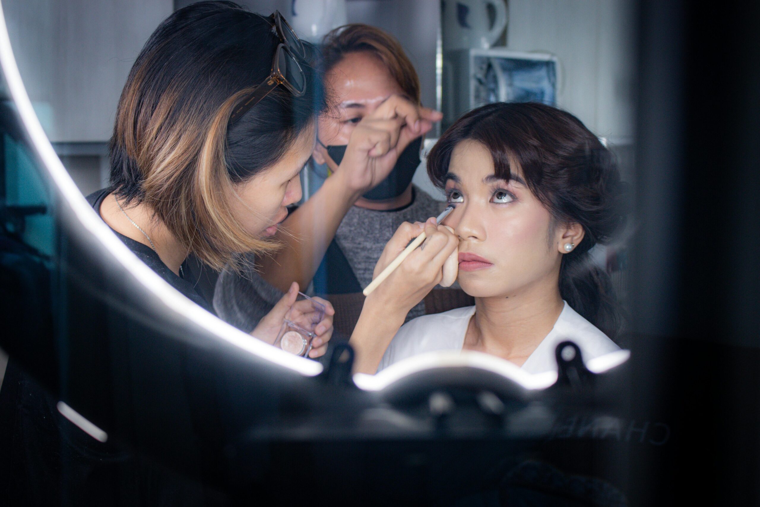A bride receiving professional skincare consultation before her wedding day