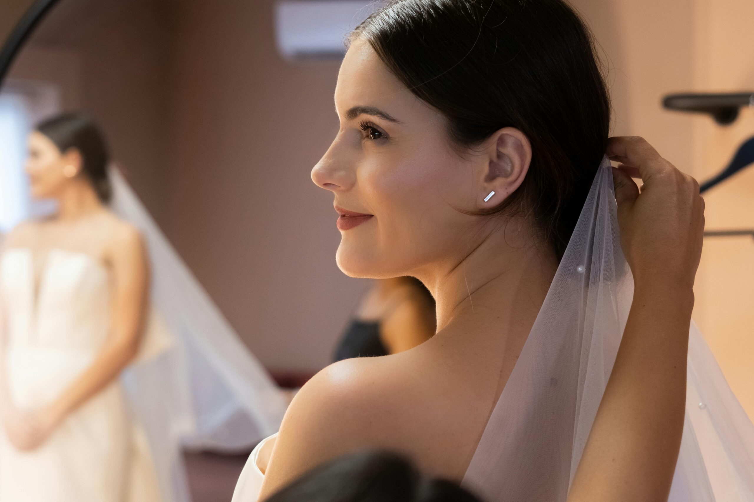 A bride smiling confidently with flawless makeup.