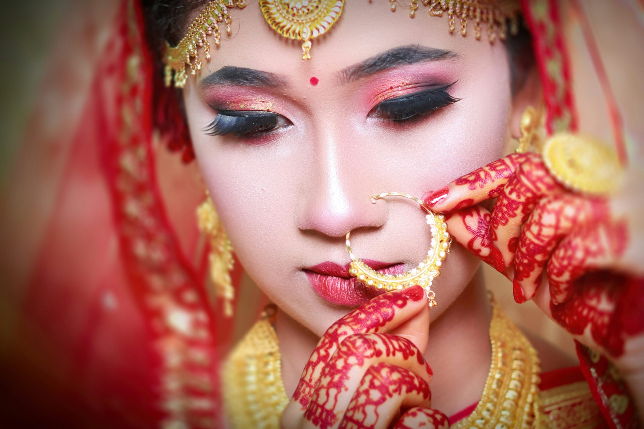 A bride wearing striking red lipstick and dramatic eyeliner