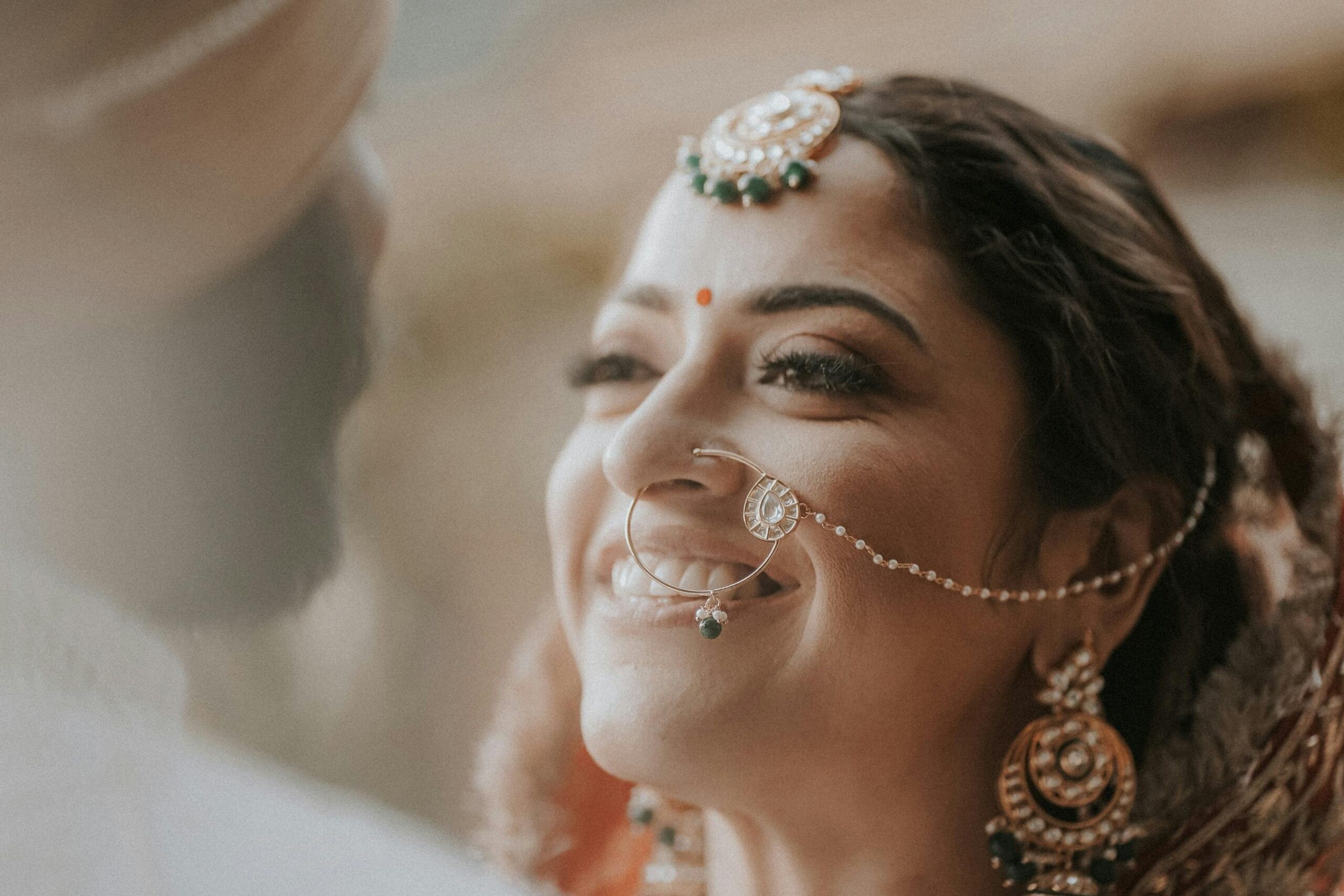 Bride crying with smudged makeup on her face at an outdoor wedding
