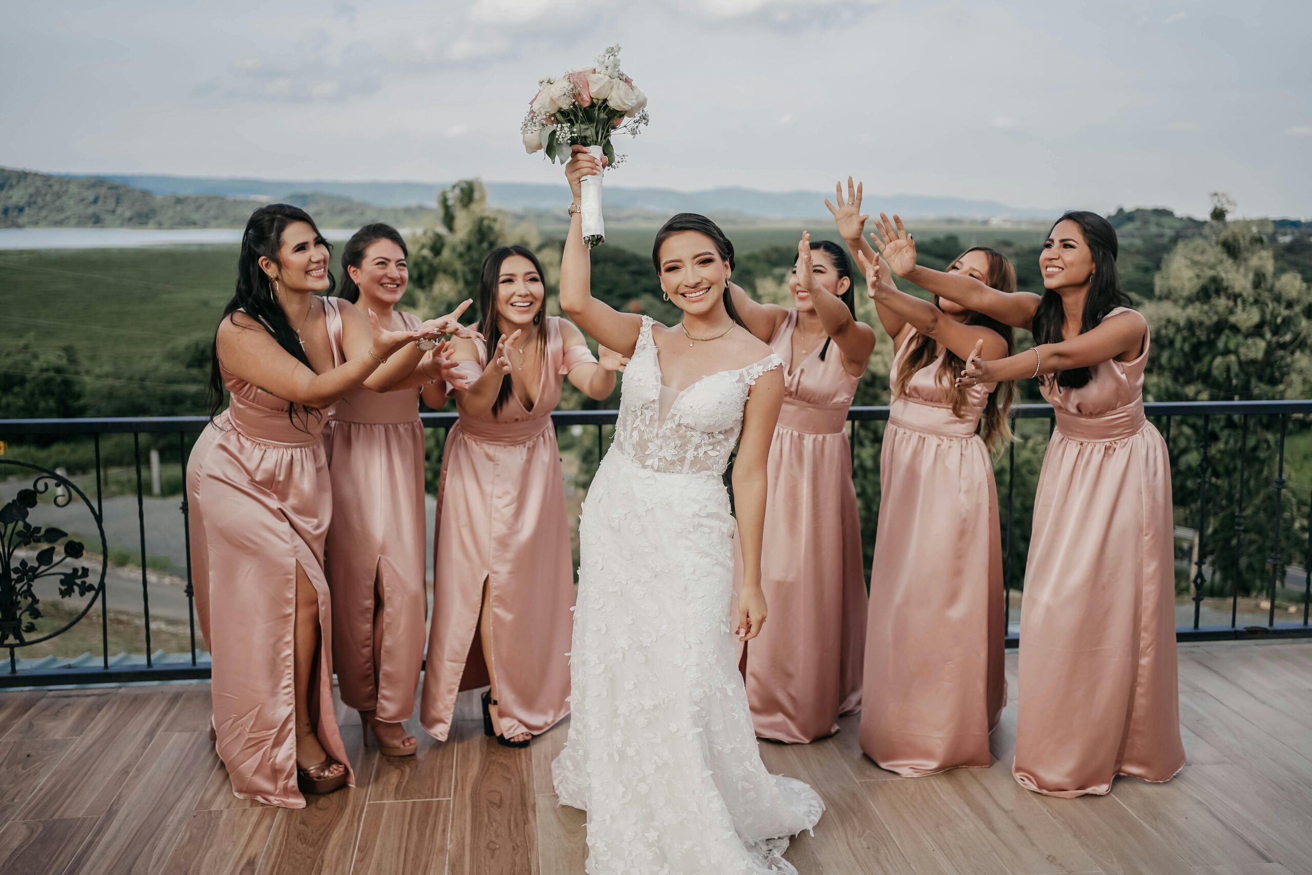 Smiling bride holding bouquet with glowing, naturally flawless bridal makeup