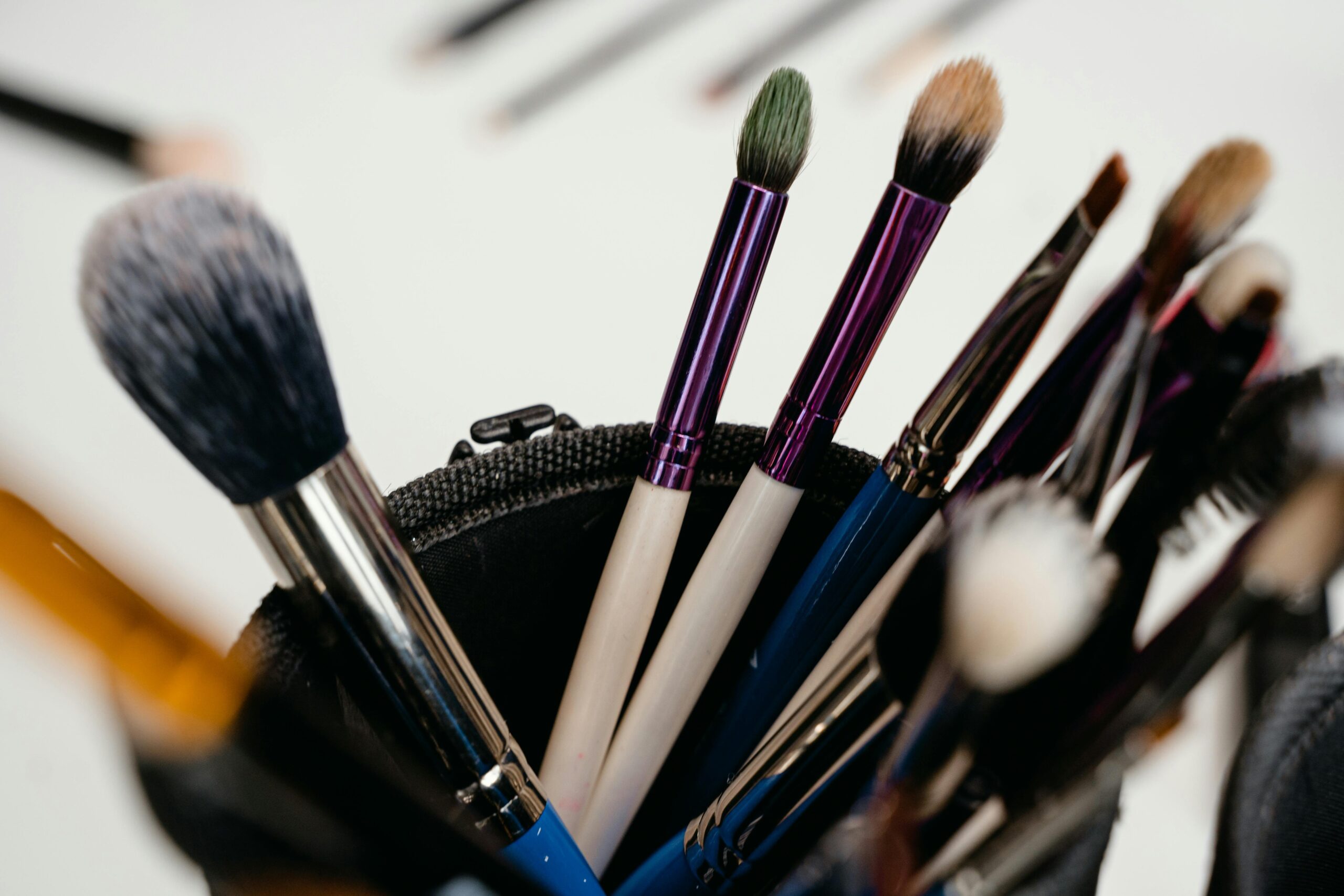 Various touch-up free makeup products including foundation, primer, and setting spray.