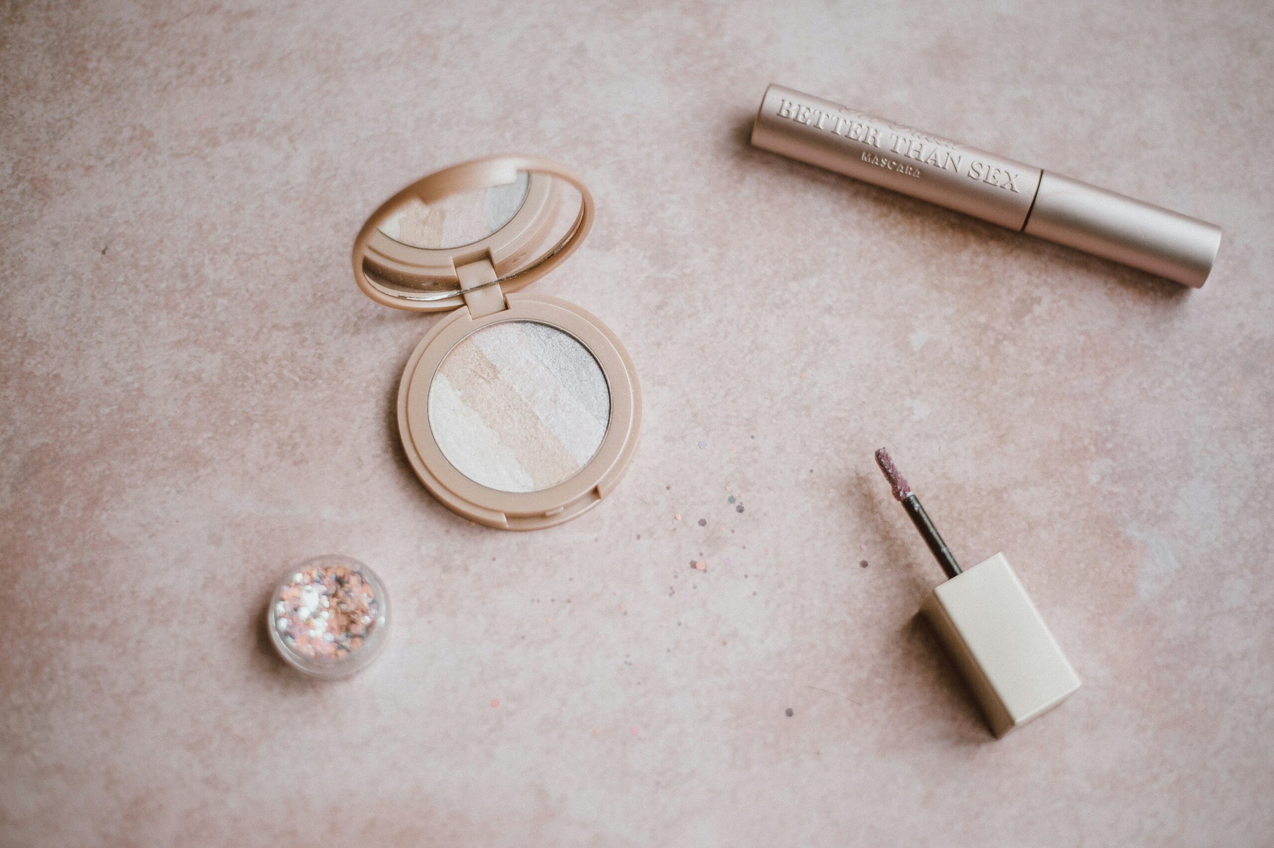 A bride smiling confidently while applying makeup