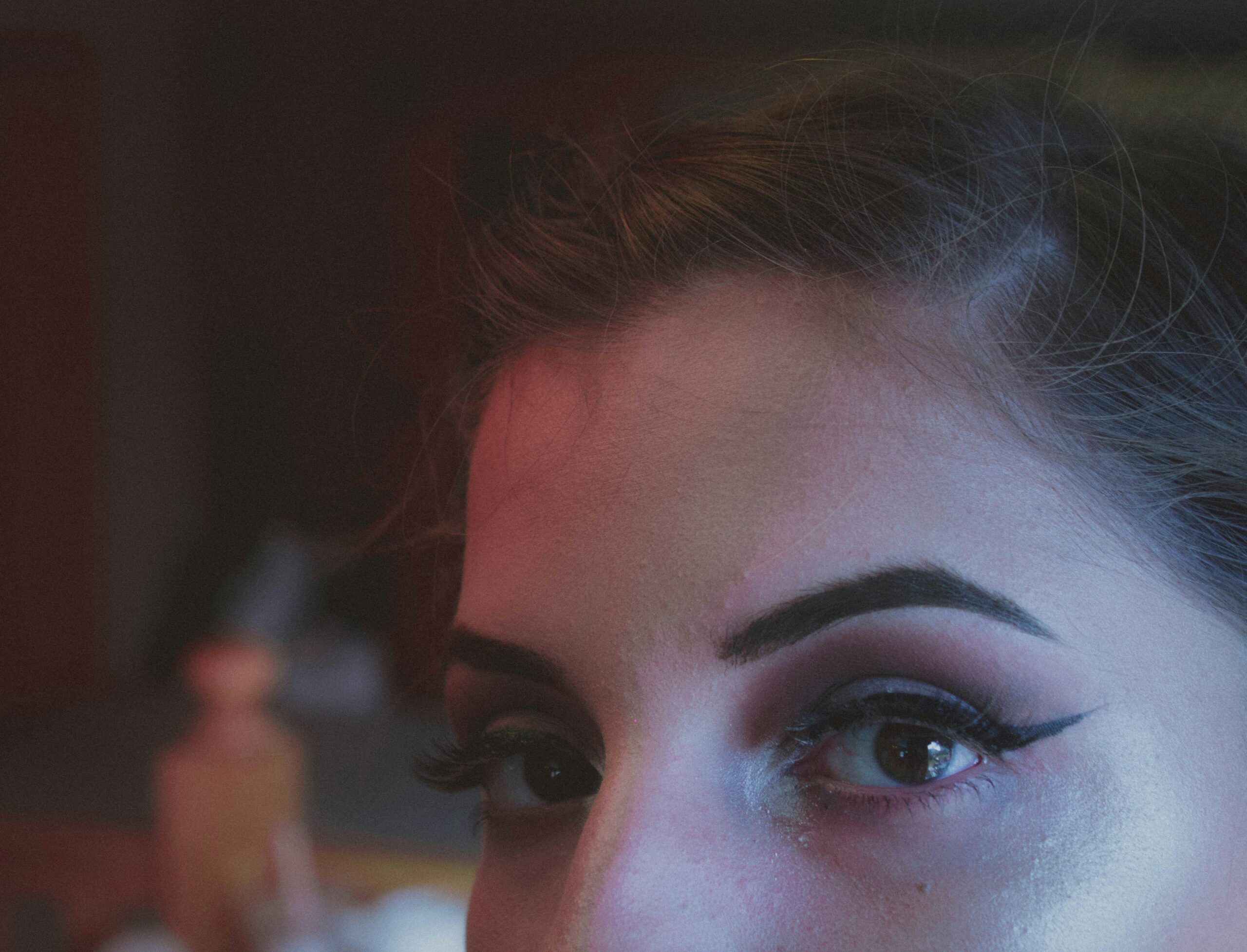 A close-up image showing uneven evening makeup melting due to poor product choice.
