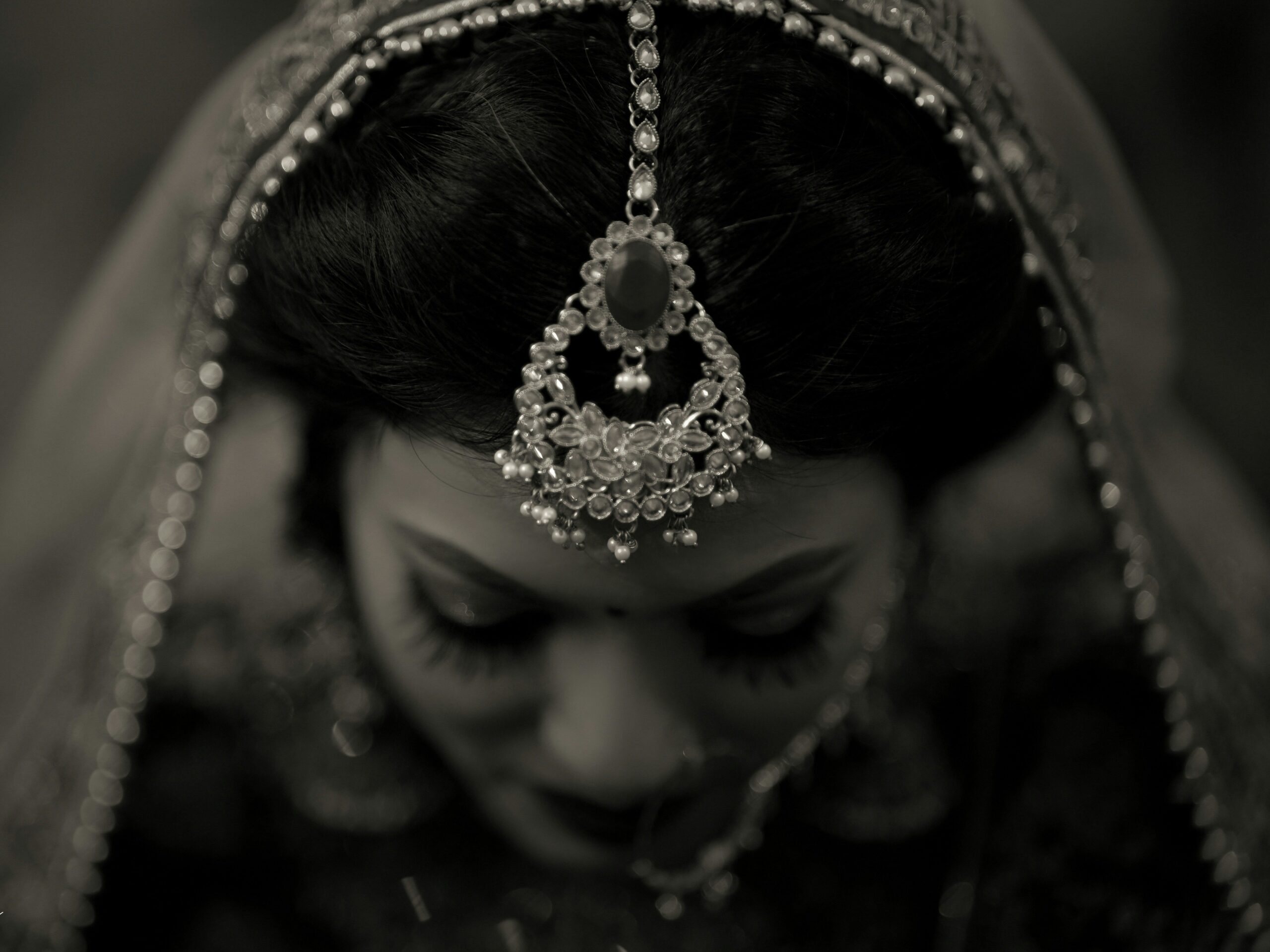 Bride touching up smeared makeup at outdoor wedding