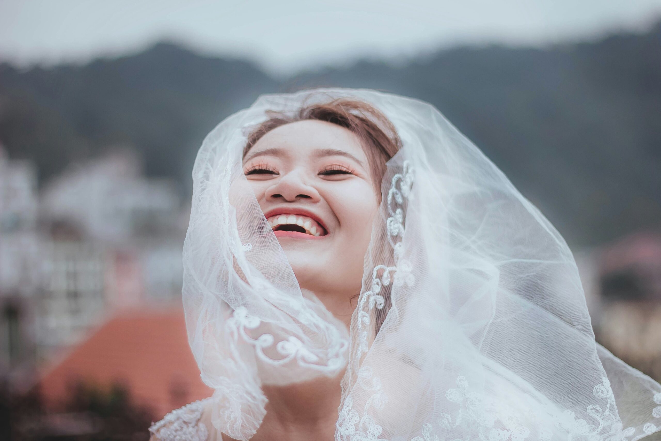 Smiling bride under string lights at evening reception