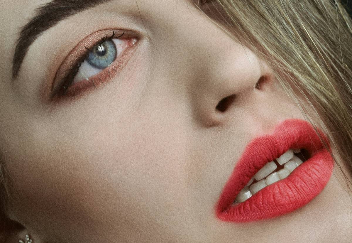 A bride holding two different lip liners, one smudged and one intact.