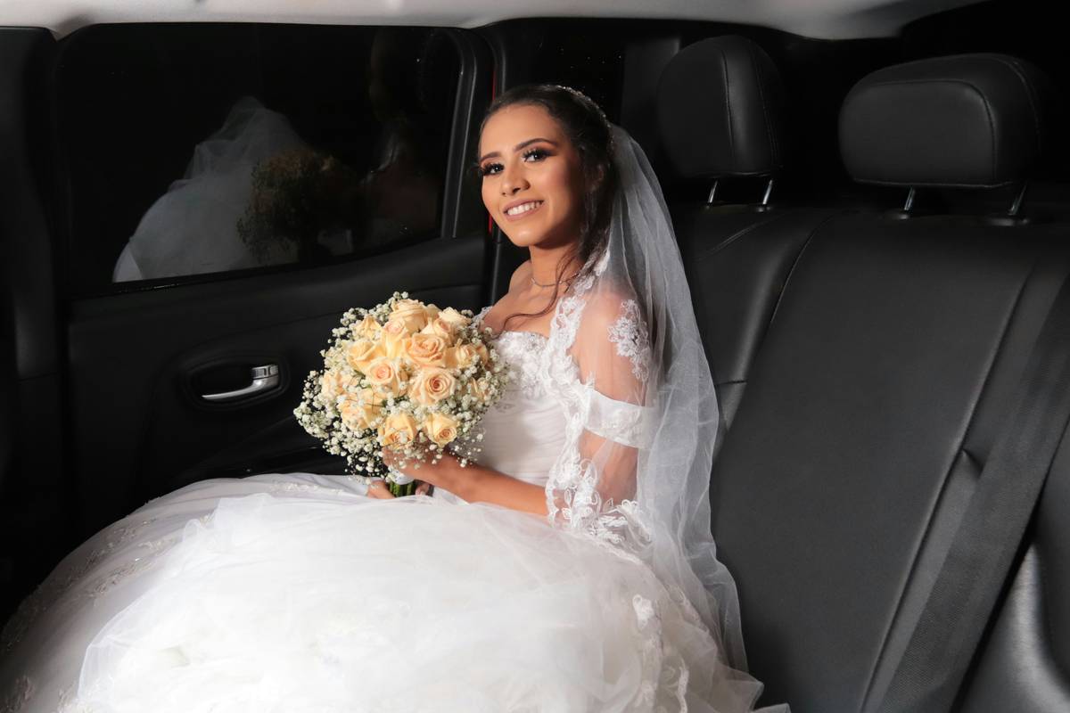 A bride smiling confidently with gold-toned eyeshadow and subtle blush.