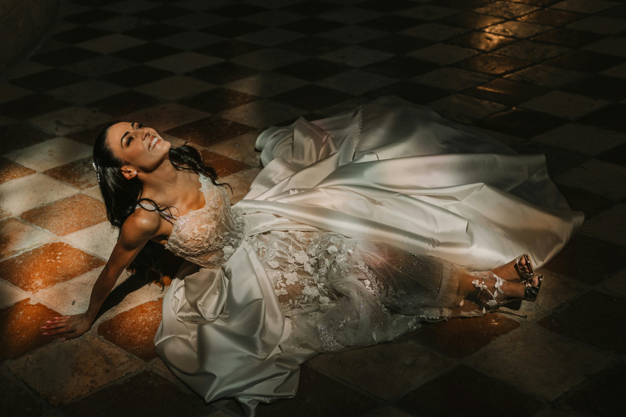 A bride touching her face, highlighting shiny areas caused by oily skin.