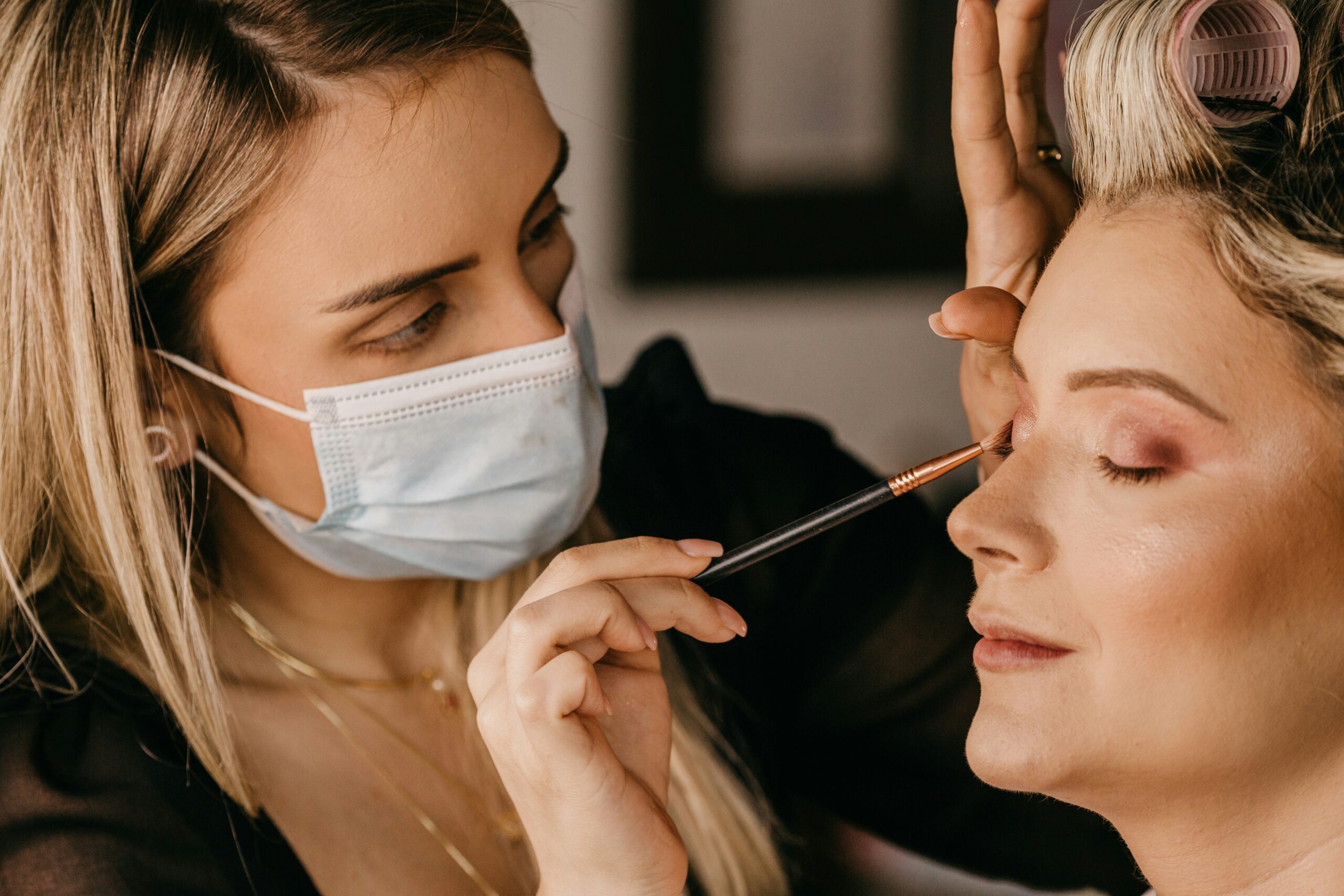A professional makeup artist setting up her kit for a formal event.