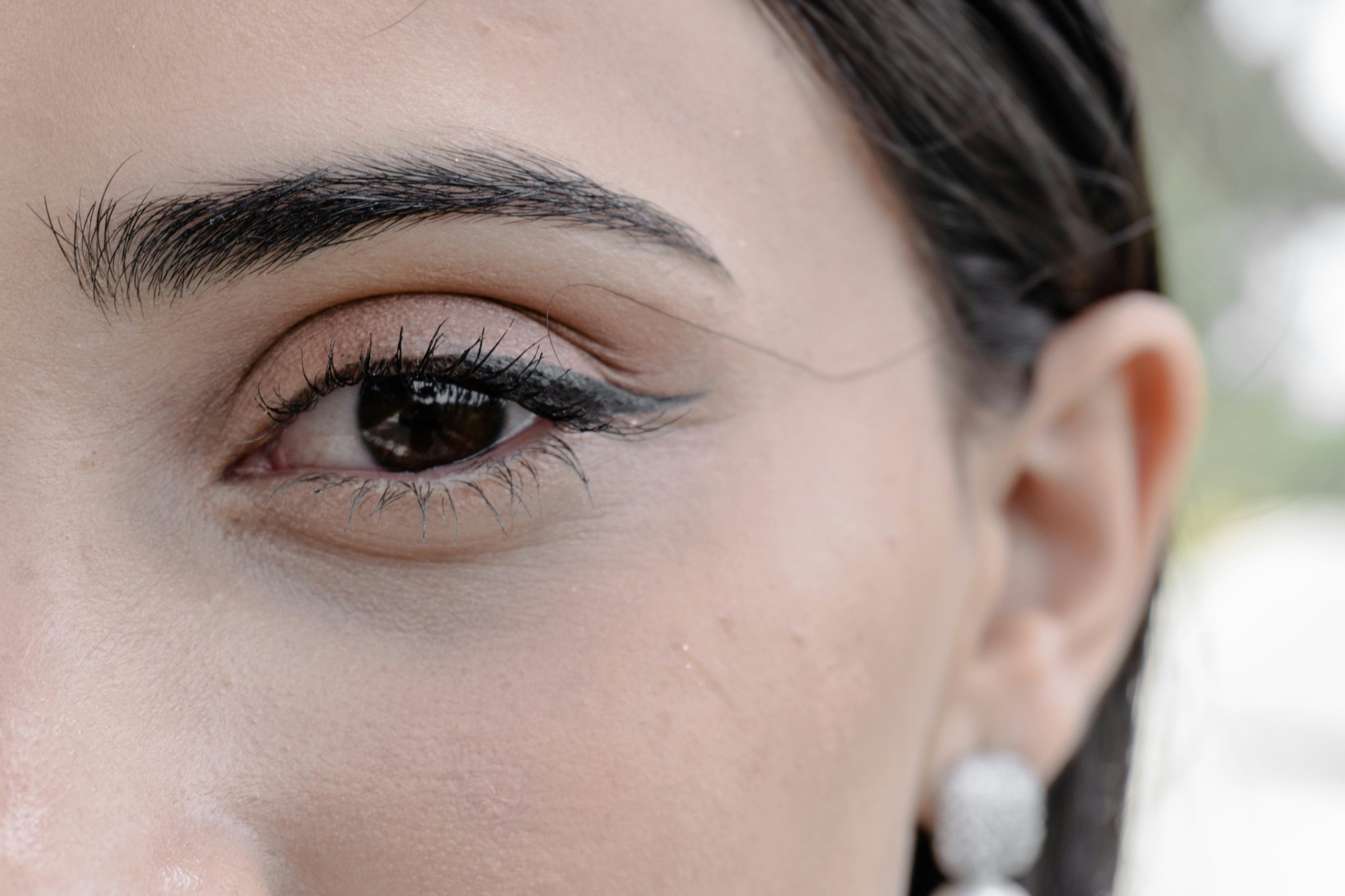 A radiant bride posing outdoors after achieving an award-show-inspired bridal makeup look