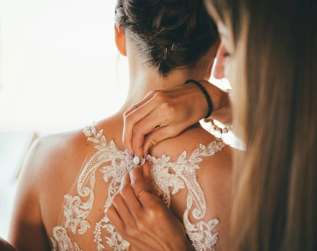 Bride smiling in her wedding dress with professional makeup