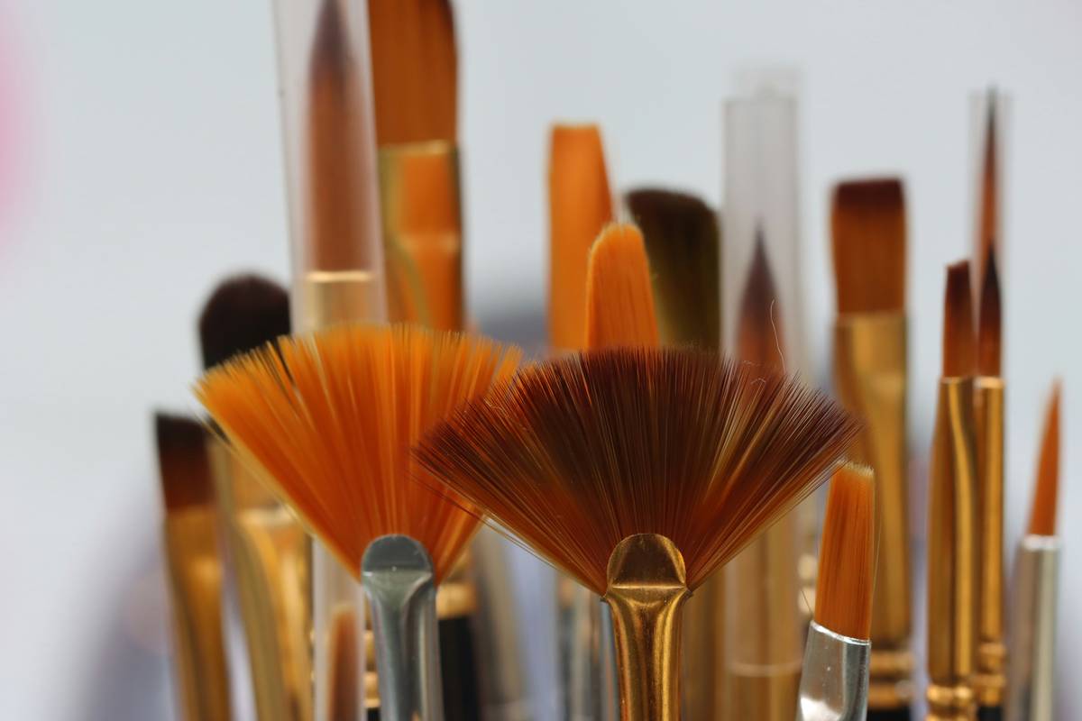 Close-up of a makeup artist using a blending brush on a model's eye.