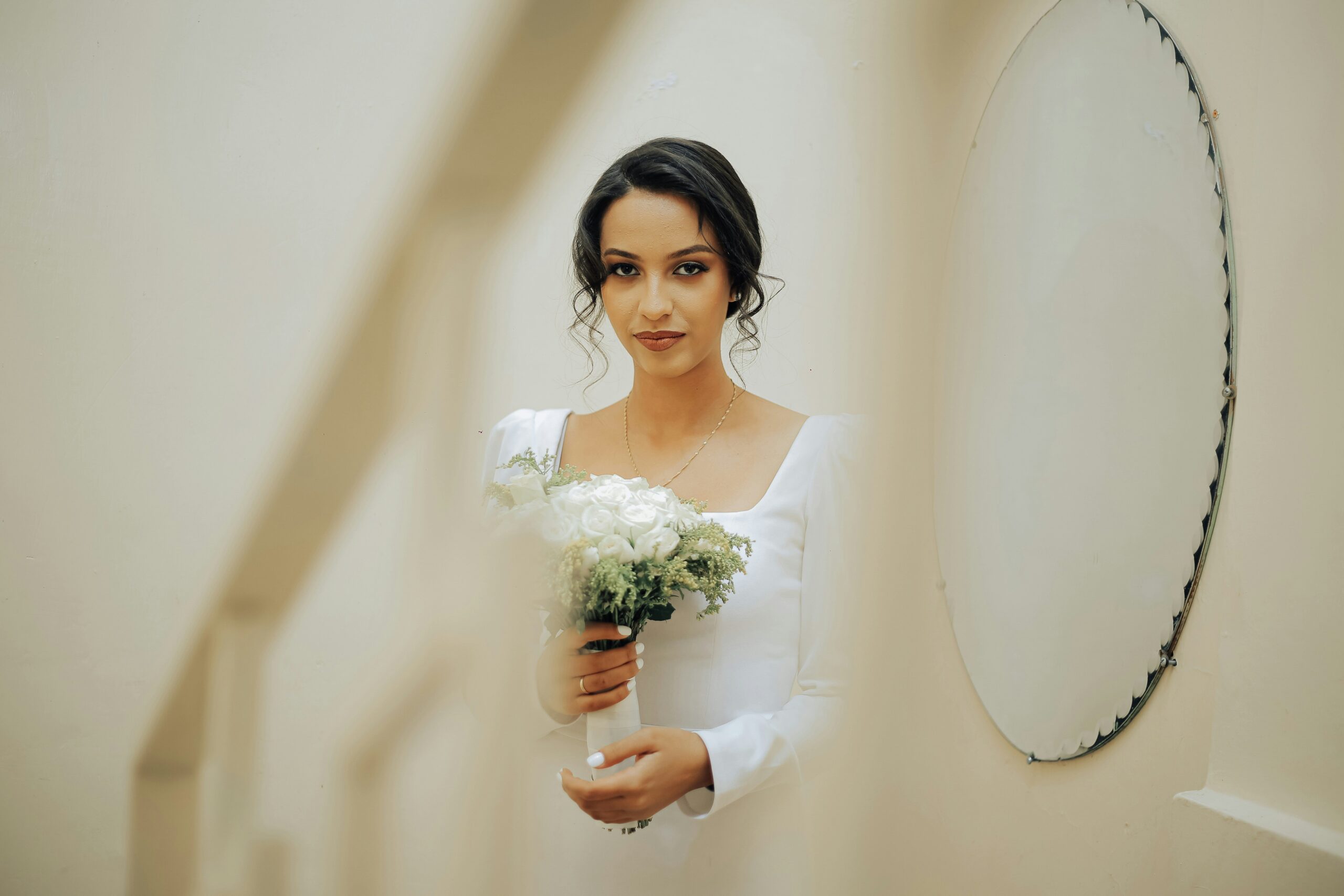 Wedding planner demonstrating usage of blotting paper on a bridesmaid