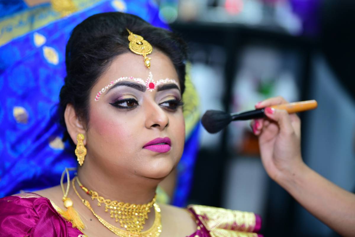 A bride holding an organized makeup box with labeled compartments