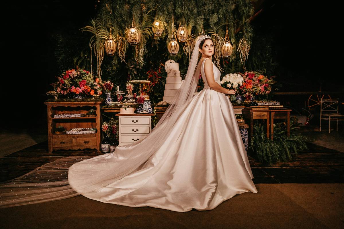 A real-life bride wearing elegant sparkling event makeup with soft pink lips and glowing cheeks