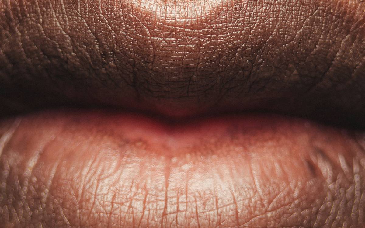 Woman testing different lipsticks at home