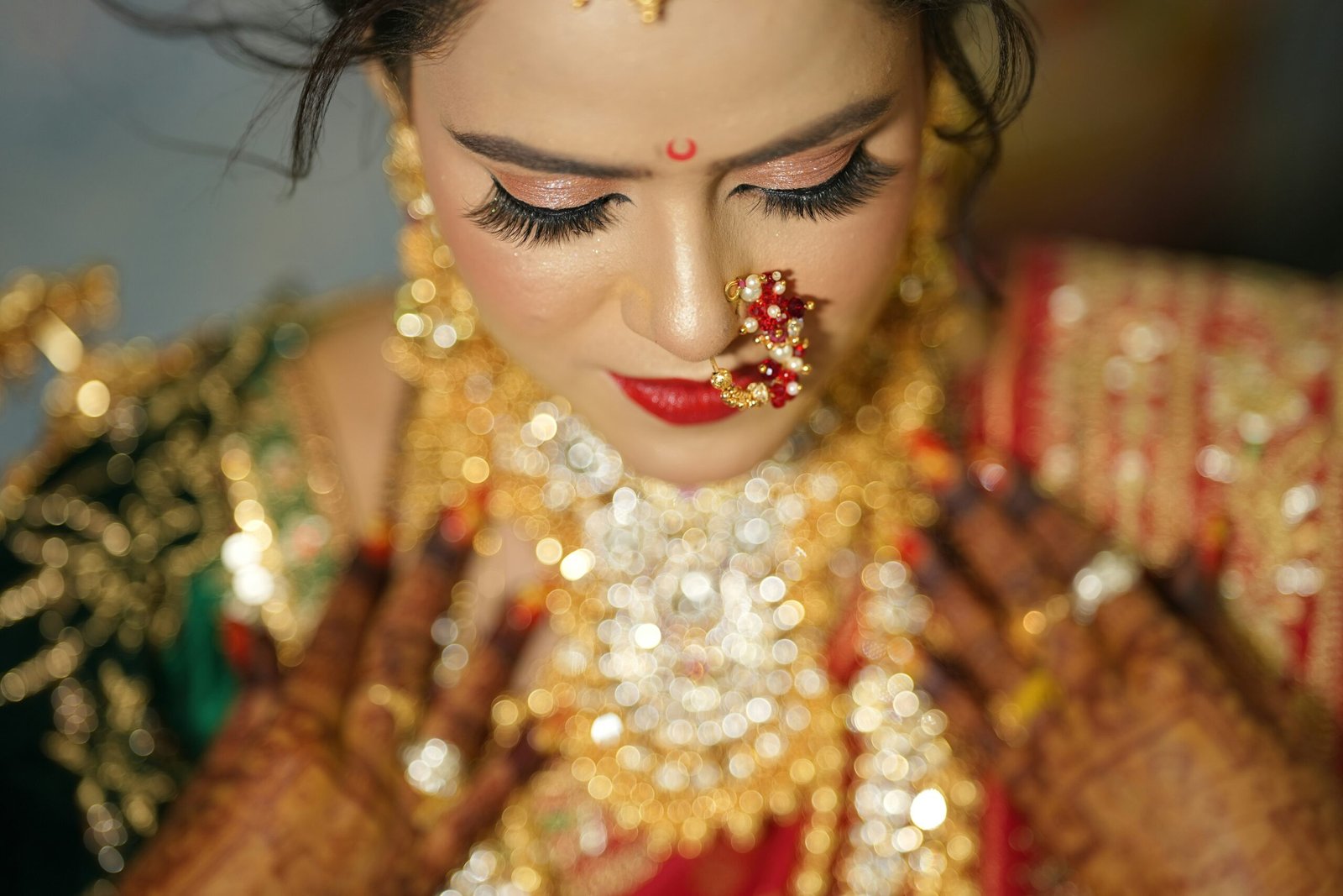 a woman wearing a gold and red outfit and jewelry