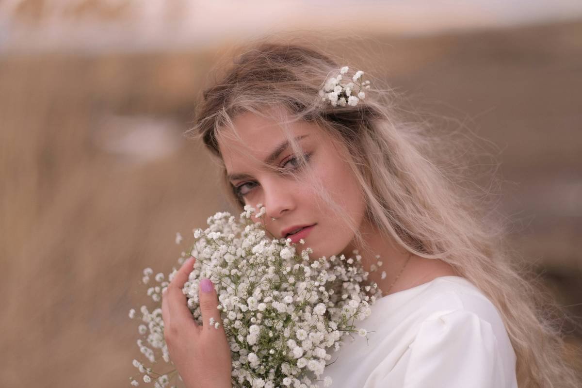 A bride holding flowers during a spring outdoor wedding