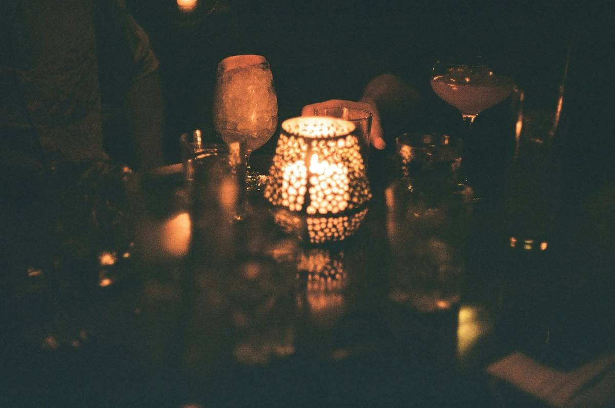 A close-up of a woman wearing elegant date night makeup featuring dewy skin, neutral eyeshadow, and glossy lips.
