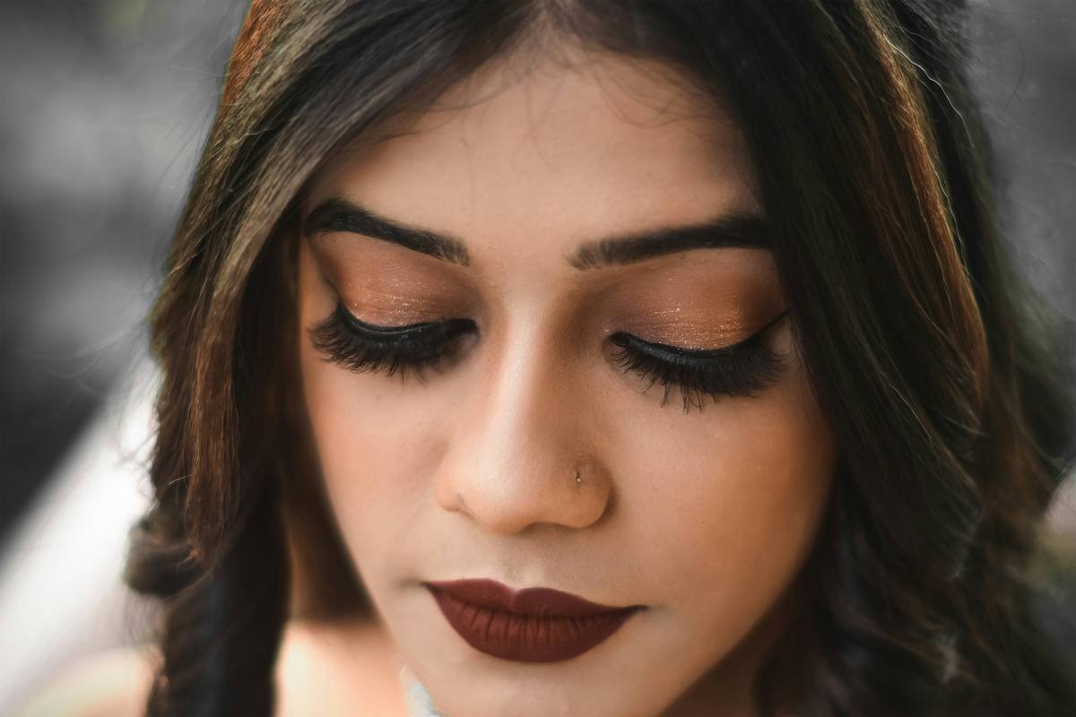 Infographic showing key differences between elegant vs. overdone bridal makeup: soft matte vs. flat matte, blended blush vs. stripey blush, defined but natural brows vs. overly drawn-on brows
